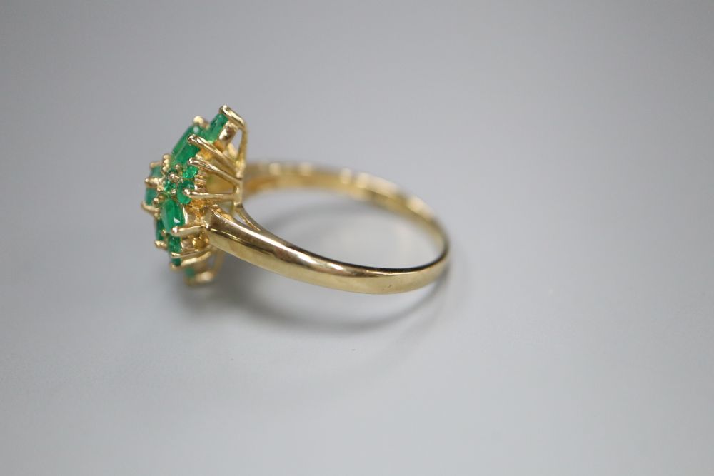 A modern 9ct gold and emerald cluster ring, size R, gross 3.4 grams.